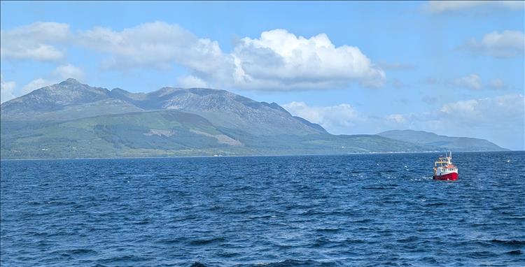 Across the waters we see the mountains of Arron rising up on a clear day