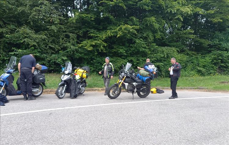 3 125s and their riders taking a break at the roadside in Germany