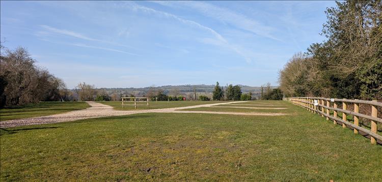 Broad open field with gravel tracks to the camping spots at the holiday park
