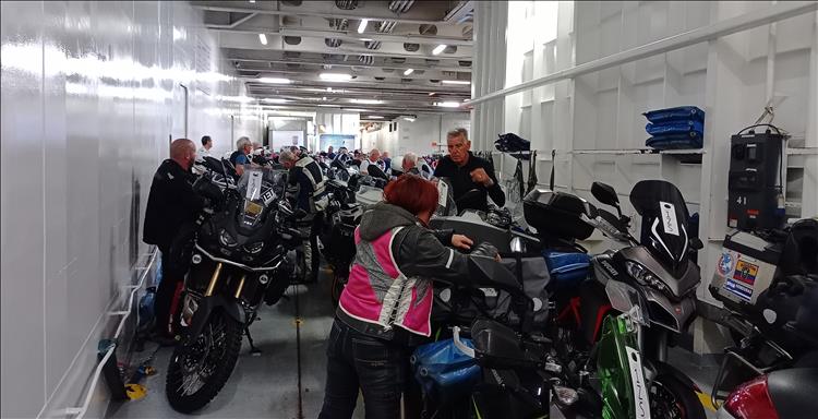 Hundreds of motorcycles and riders all clamouring to get their bikes unstrapped and ready to ride
