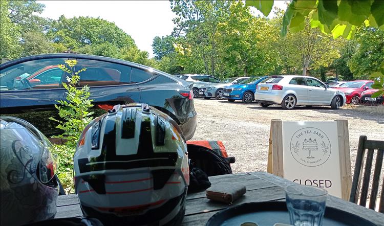 We can only see the car park and the edge of a table at the cafe