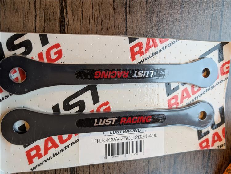 2 dog bone shaped bits of metal in the smart Lust Racing packet