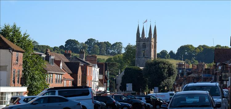 The street, parked cars, shops and church of Marlborough's main street