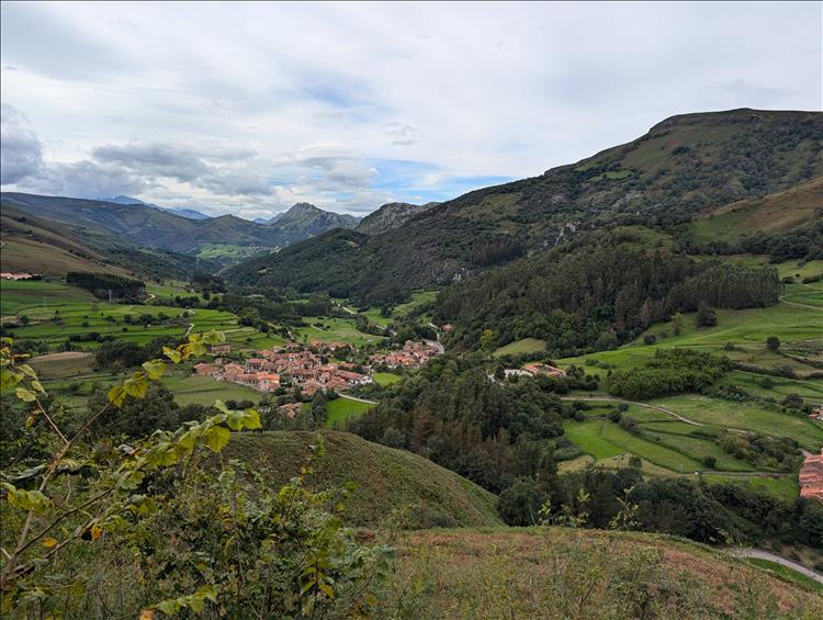 Valleys and hills green and lush with a small town down in the valley