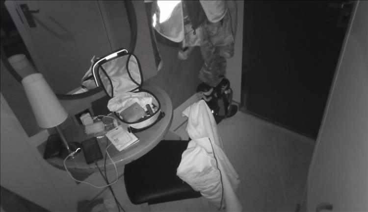Black and white night vision scene inside the tiny cabin on the boat