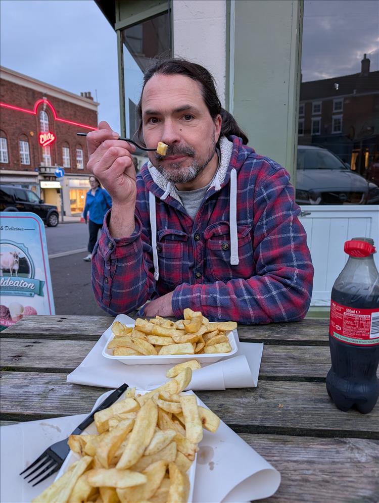 Ren eating chips outside on a bench in Ashbourne