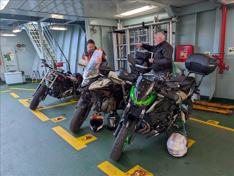 3 bikes parked facing out on the ferry