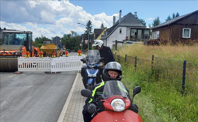 Roadworks vehicles, barriers and frustrated riders East Germany