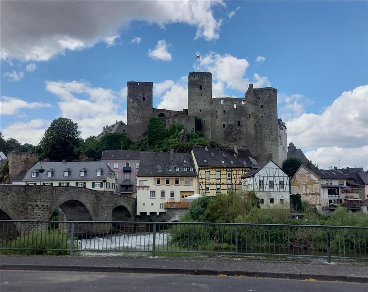 A large medieval castle dominates the small hill above the old town