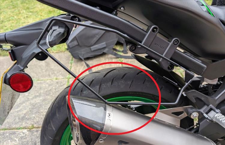 The frame that holds the Shad side bags touches the exhaust