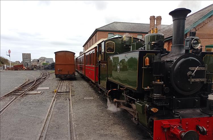 A small stout steam engine and a handful of carriages at the Talyllyn Railway