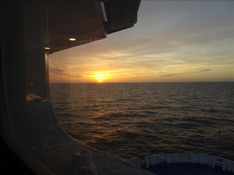 From the cabin winder we see the sea, the bow of the ship and a glorious sunset