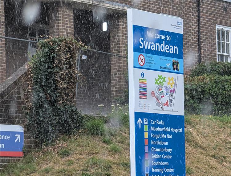The hospital sign says Swandean and we can clearly see huge raindrops falling