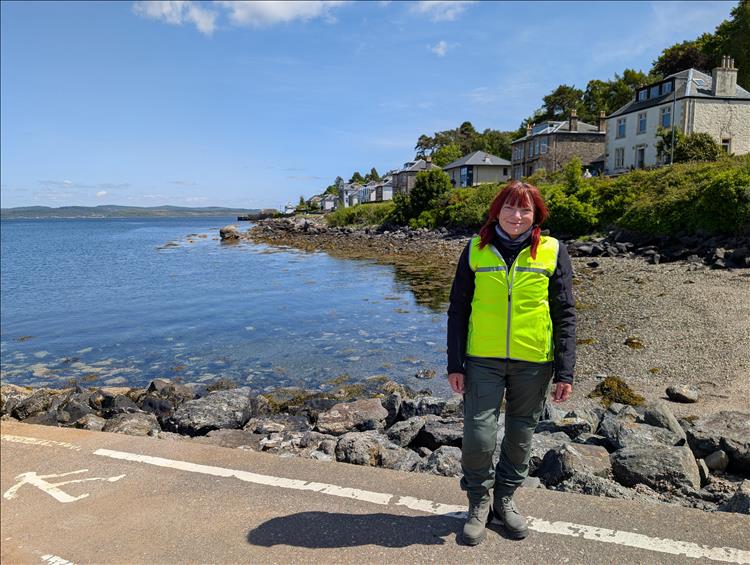 Sharon in her bike gear by the shore at the ramp for the Portavadie ferry