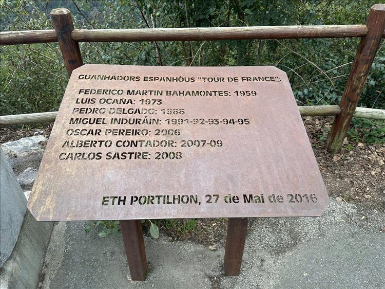 A rusty steel plate with letters laser cut out of it. It list names and dates, presumably of competitors who died