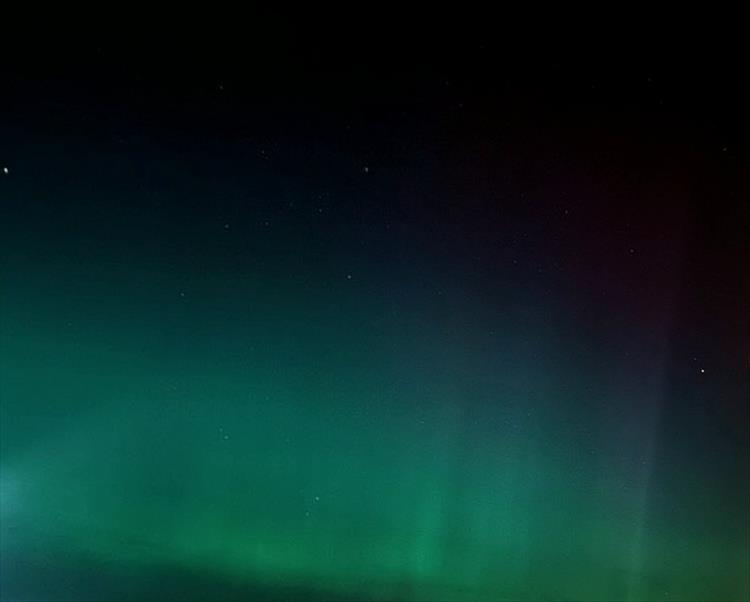 The green hues faint across the skies of the Northern Lights