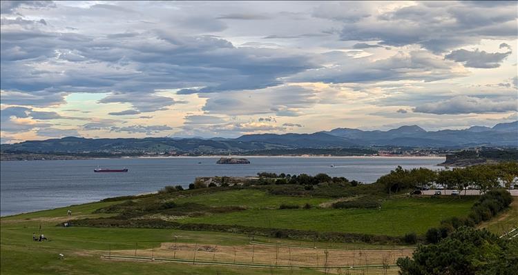 Across a bay we see almost endless hills as we look across from the lighthouse