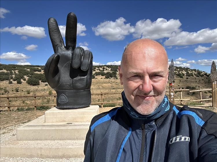 Andy stands by a massive leather glove giving a V sign