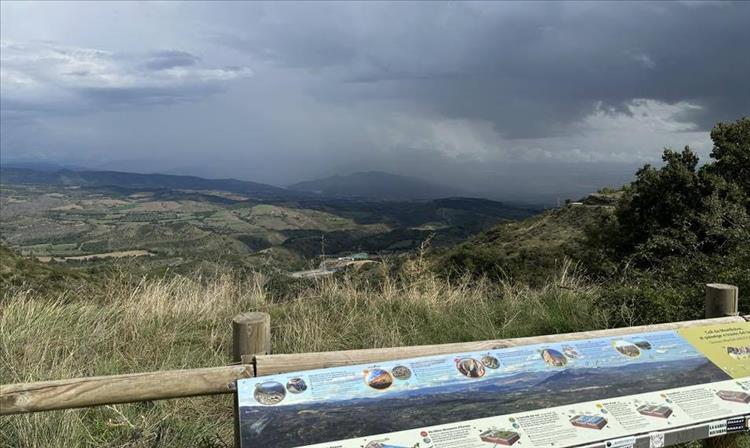 Looking into the distance we see black clouds and heavy rain over hills