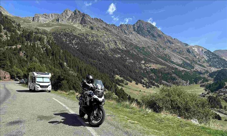 Amazing scenery, rocky mountain tops, the road and trees and Andy's GS1250