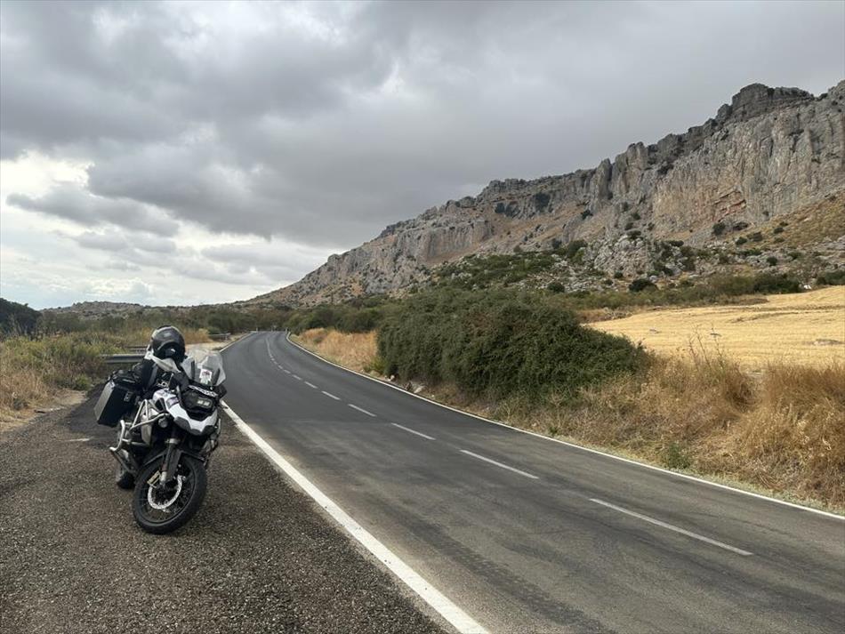 Andy's GS parked by the road with rocky moutains behind