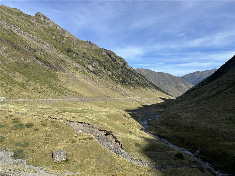 Steep valley walls and a narrow stream in the dramatic landscape shot