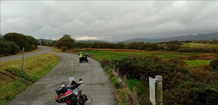 Heavy skies, endless mountains, Sharon waving at the camera, and the bikes