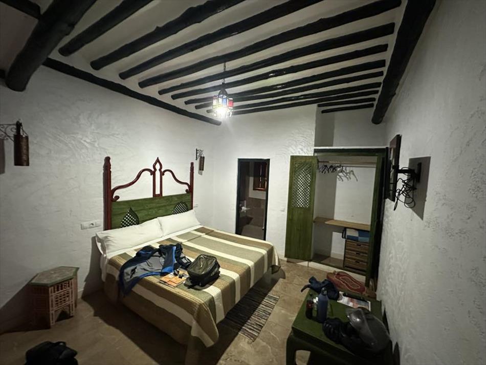 A room with white walls and black beams, quite basic but clean and pleasant