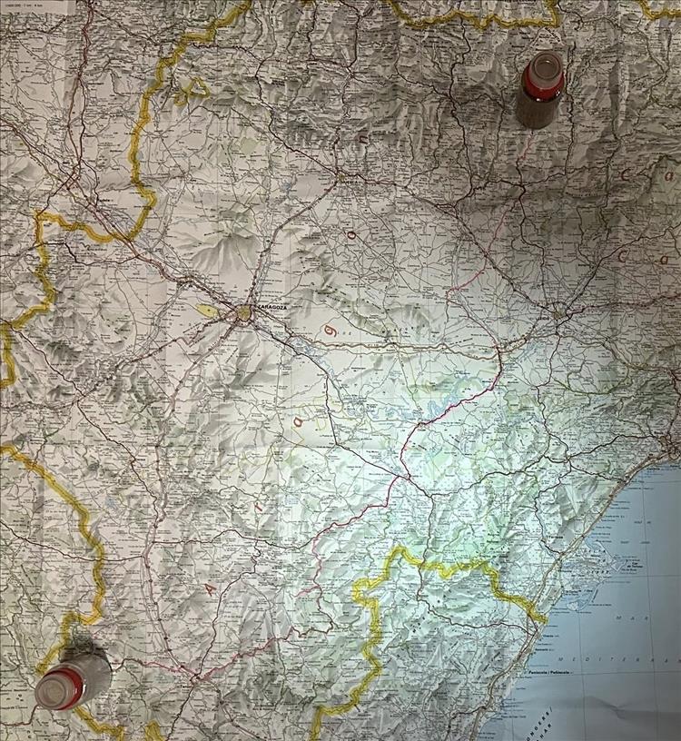 An old school paper map with a salt and pepper pot to show where Andy started and finished