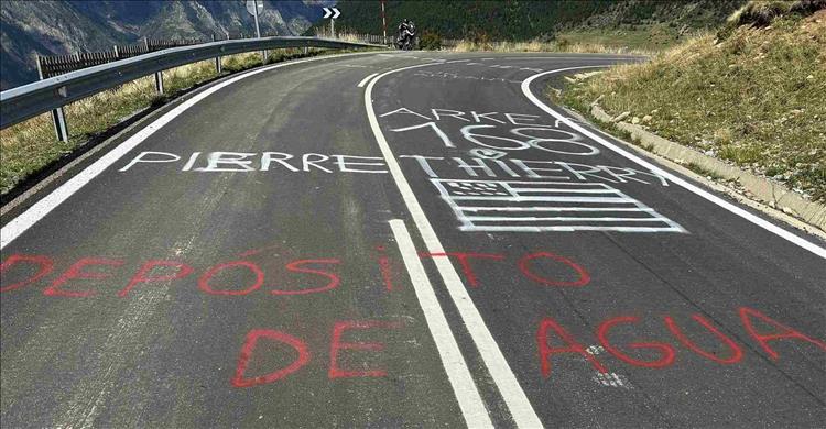 The mountain road has various rider's names spray painted on it