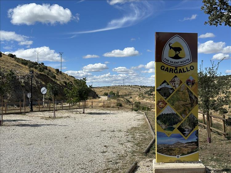 A distinctive board declaring the start of the silent route against the arid landscape