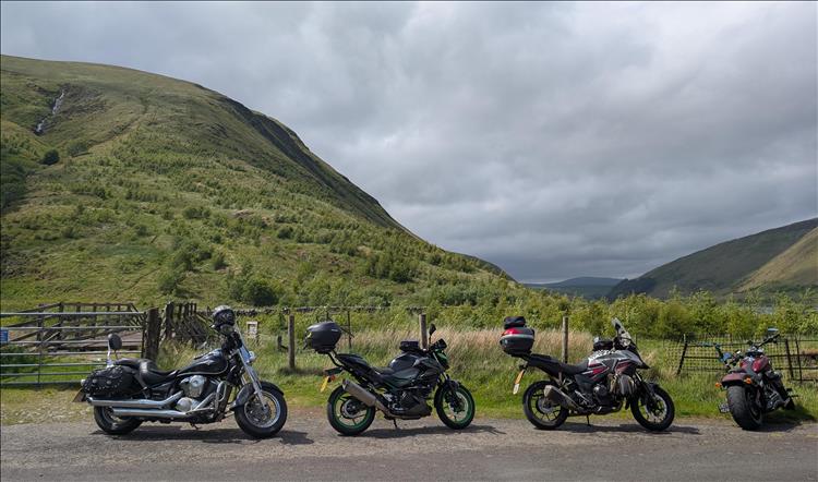 4 motorcycles and the steep valley and impressive scenery at Talla Linnfoots