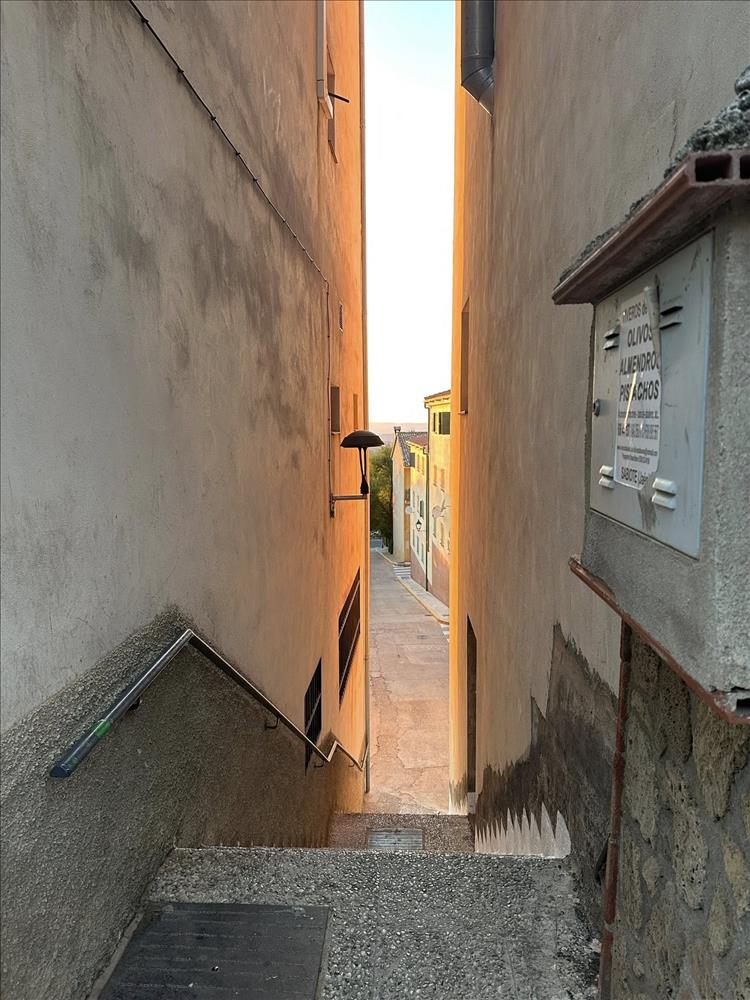 tall thin image of a tall thing gap between buildings and views beyond