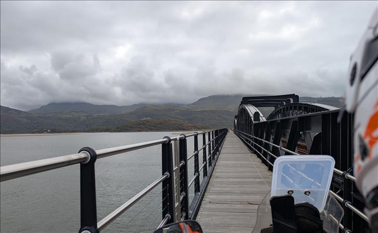 Looking over Ren's shoulder on the bike we see the steel bridge and the wooden path