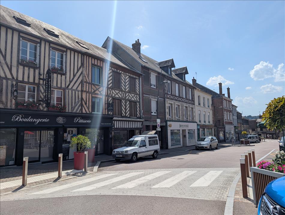 A typical small french town centre with timber framed buildings along a broad street