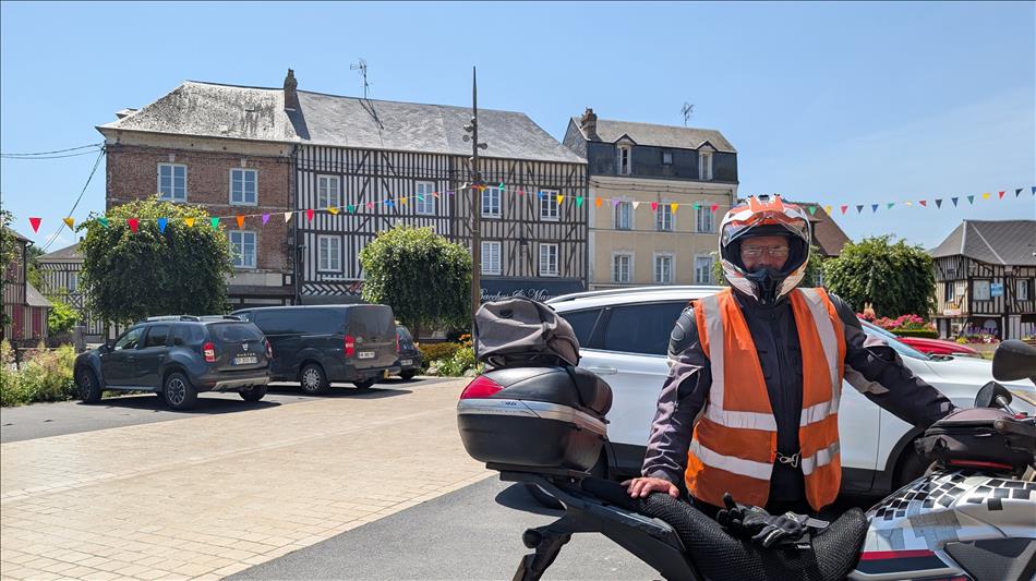 Ren in full bike gear and hot sunshine in Moyaux town centre