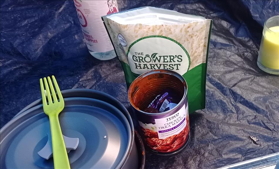 An empty tin of chicken tikka masala and an empty packet of ready cooked rice