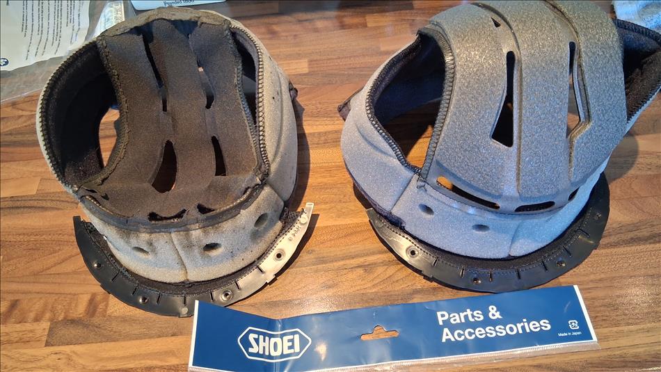 A scruffy old helmet liner next to a clean new one
