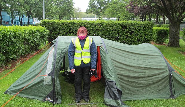 Sharon looking very wet and miserable outside a tent in France
