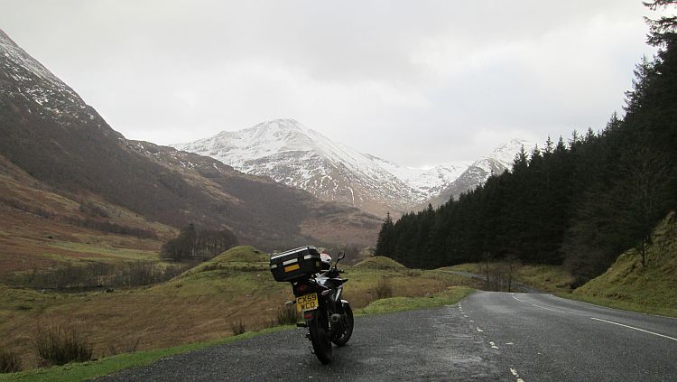 a motorcycle in a snowy valley looking all wild