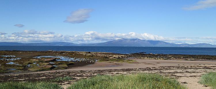 Looking across the waters to the Isle of Arron. Mountains in the distance.