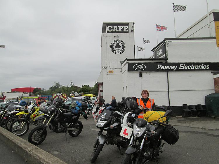 Sharon stands next to our bikes outside the Ace Cafe