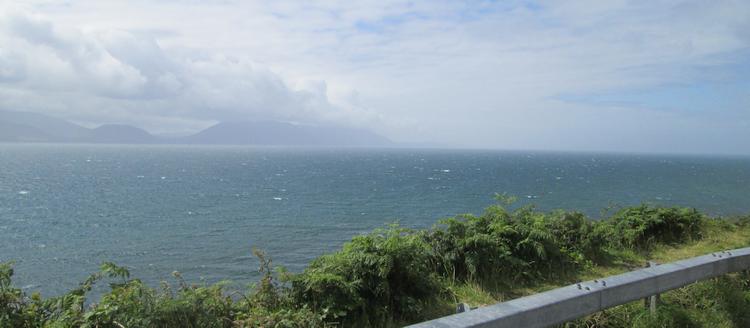 Looking across a large vast bay to hills in the distance from the Dingle Peninsula