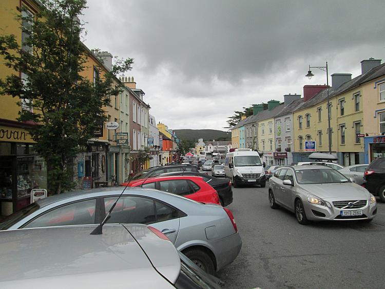 A car filled and busy main street through Kenmare