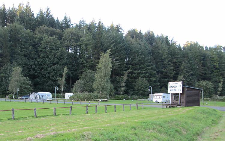 A local rugby club with some caravans on a patch of grass nearby. Ewes Water