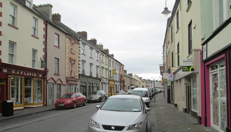 Lostowel town centre, a long row of terraced shops and houses but if good order