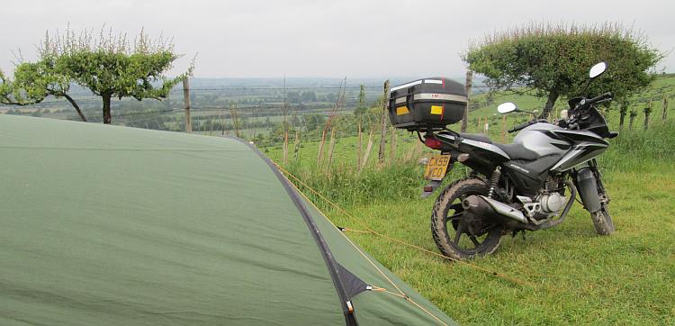 Ren's 125cc motorcycle and the tent overlooking the countryside around leighton buzzard