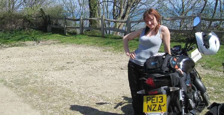 Sharon poses next to her bike in her supermodel style