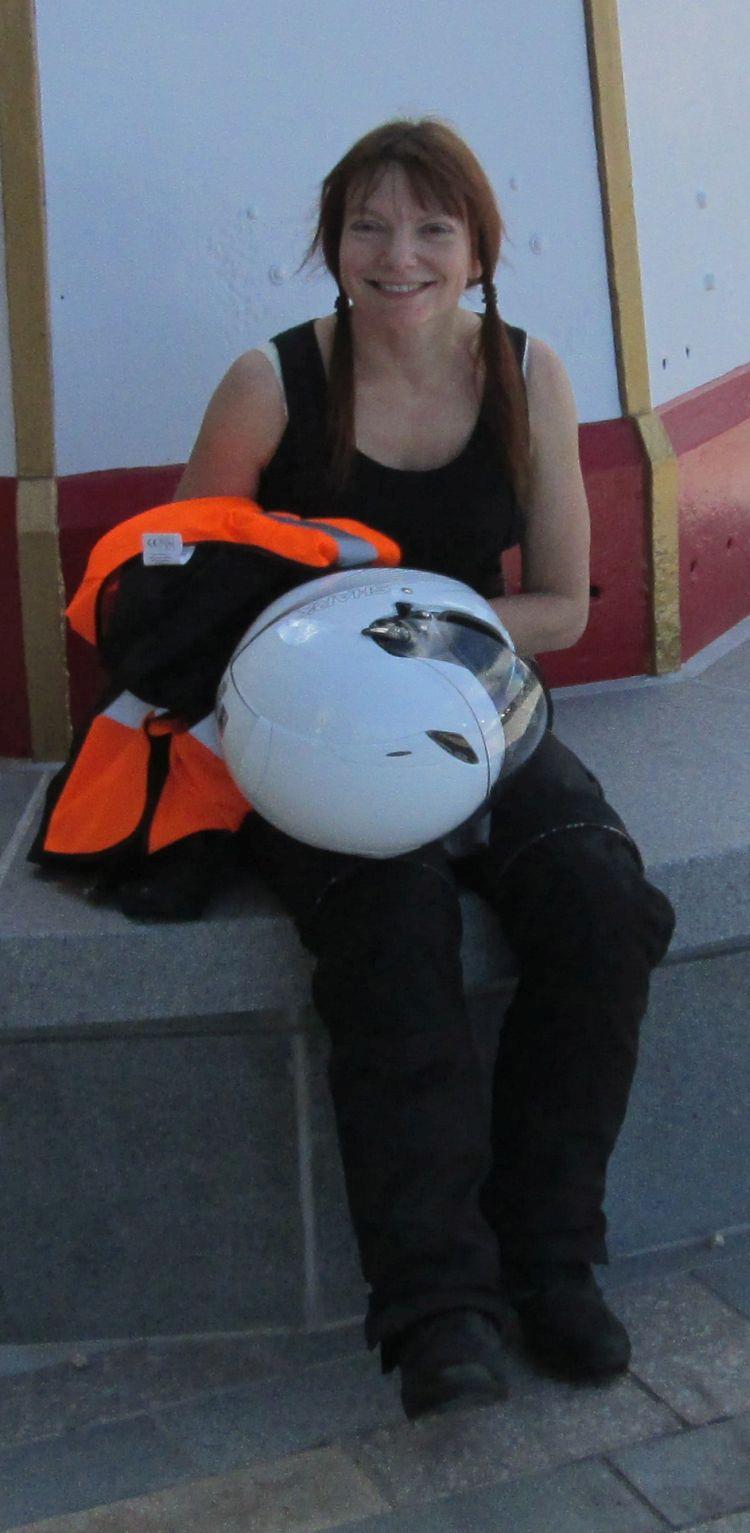 Sharon smiles with her bike gear after her successful trip