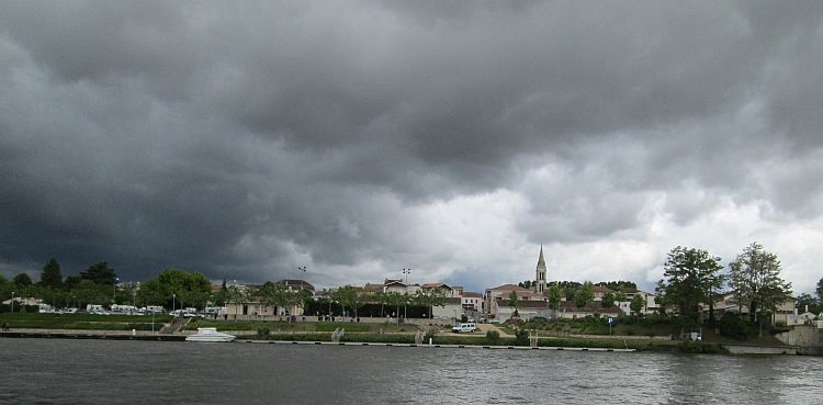 thick heavy clouds gather over a french town
